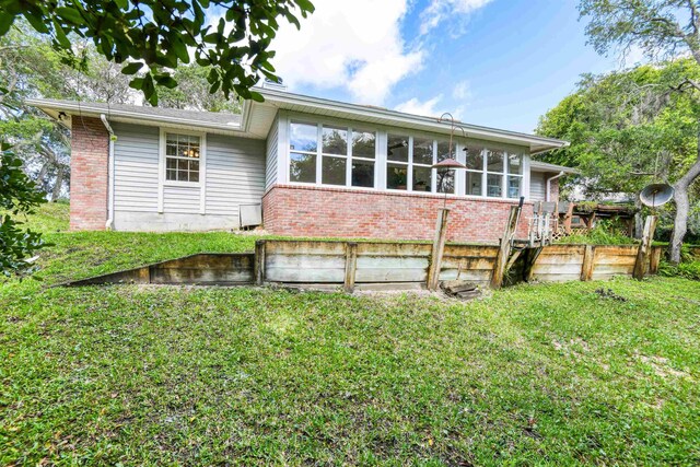 1536 San Rafael Way, Saint Augustine, FL 32080 - back of house featuring brick siding and a yard