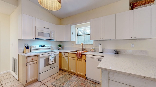 kitchen featuring light tile patterned flooring, white appliances, white cabinetry, and sink