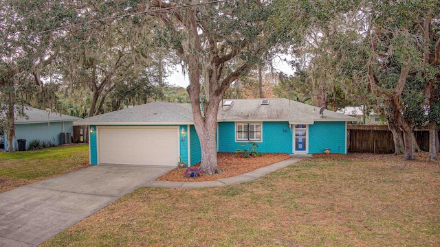 ranch-style house featuring a garage, a front yard, and central AC