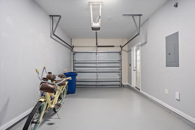 garage with a garage door opener, electric panel, and baseboards