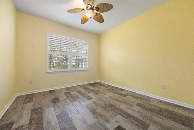 spare room with ceiling fan, baseboards, and wood finished floors