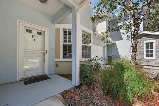 property entrance featuring stucco siding