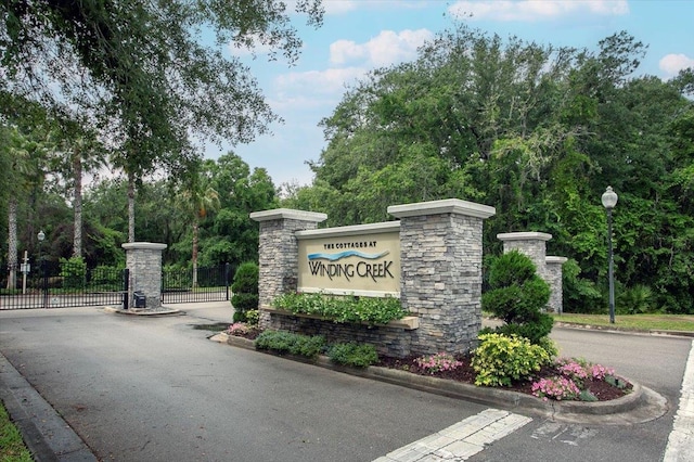 community sign with a gate and fence