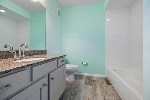 full bathroom featuring visible vents, baseboards, toilet, wood finished floors, and vanity