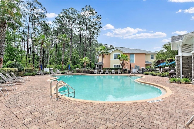 pool featuring fence and a patio