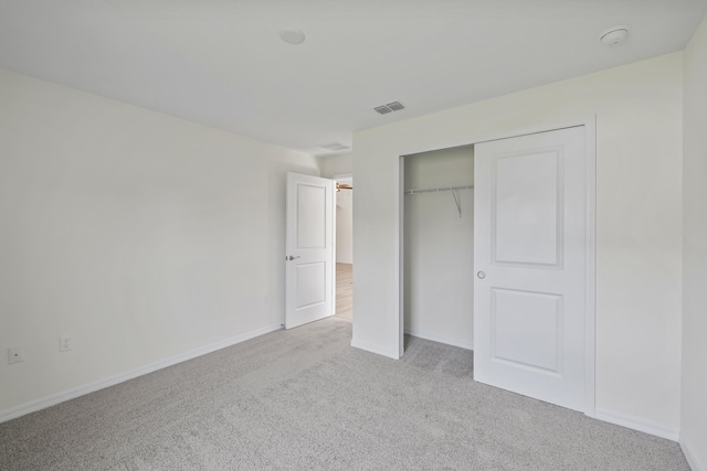 30 Palm Ln, Palm Coast, FL 32164 - unfurnished bedroom with carpet flooring, a closet, and baseboards