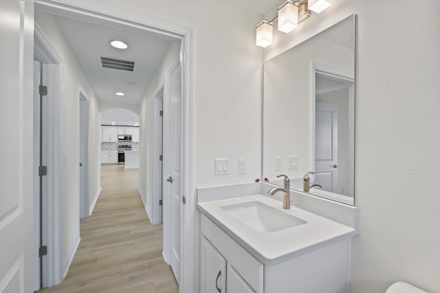 30 Palm Ln, Palm Coast, FL 32164 - bathroom with wood finished floors, vanity, and recessed lighting
