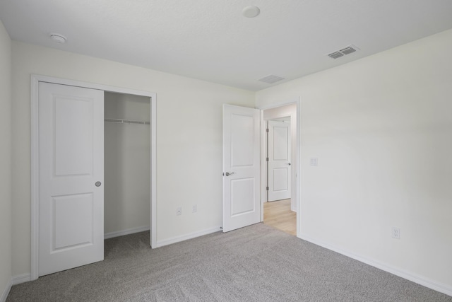 30 Palm Ln, Palm Coast, FL 32164 - unfurnished bedroom with carpet, baseboards, and a closet