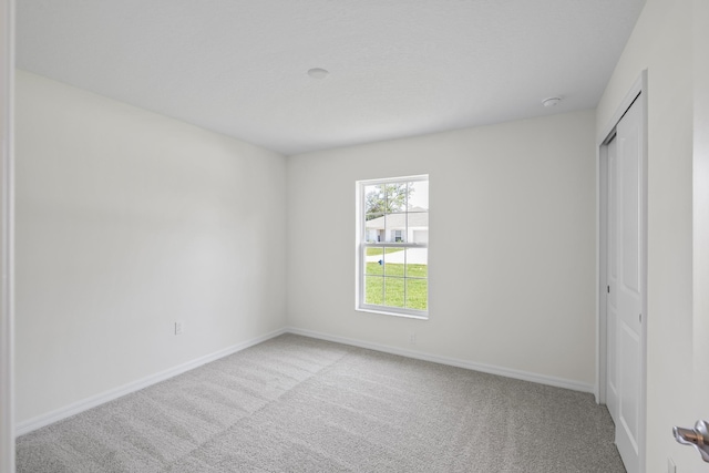 30 Palm Ln, Palm Coast, FL 32164 - unfurnished bedroom with light carpet, baseboards, and a closet