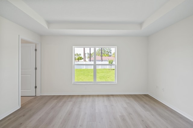 30 Palm Ln, Palm Coast, FL 32164 - spare room featuring a raised ceiling, light wood-type flooring, and baseboards