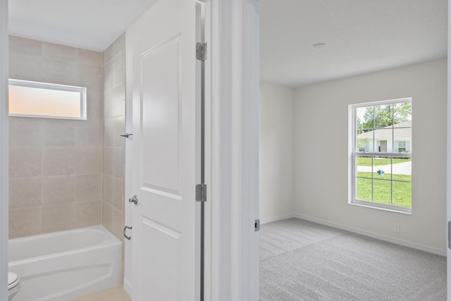 30 Palm Ln, Palm Coast, FL 32164 - bathroom with toilet, washtub / shower combination, and baseboards