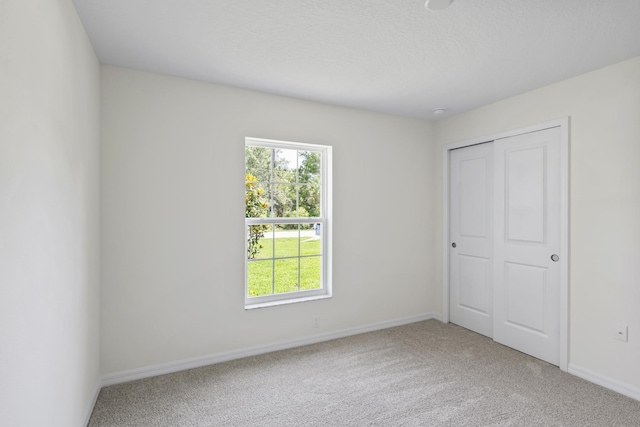 30 Palm Ln, Palm Coast, FL 32164 - unfurnished bedroom with carpet flooring, baseboards, and a closet