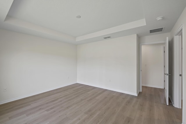 30 Palm Ln, Palm Coast, FL 32164 - unfurnished room with a raised ceiling, light wood-type flooring, baseboards, and a smoke detector