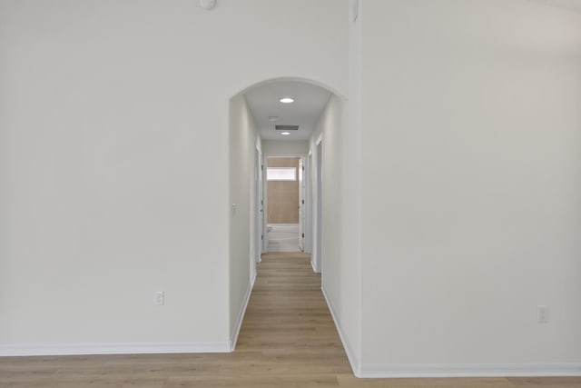 30 Palm Ln, Palm Coast, FL 32164 - hall with arched walkways, baseboards, light wood-type flooring, and recessed lighting