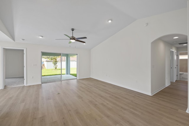 30 Palm Ln, Palm Coast, FL 32164 - unfurnished living room with vaulted ceiling, a ceiling fan, arched walkways, light wood-style floors, and recessed lighting