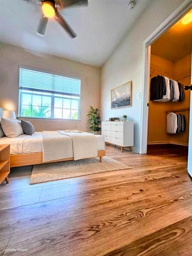 130 Bayberry Cir Unit 1501, Saint Augustine, FL 32086 - bedroom with multiple windows, wood finished floors, vaulted ceiling, a ceiling fan, and a spacious closet