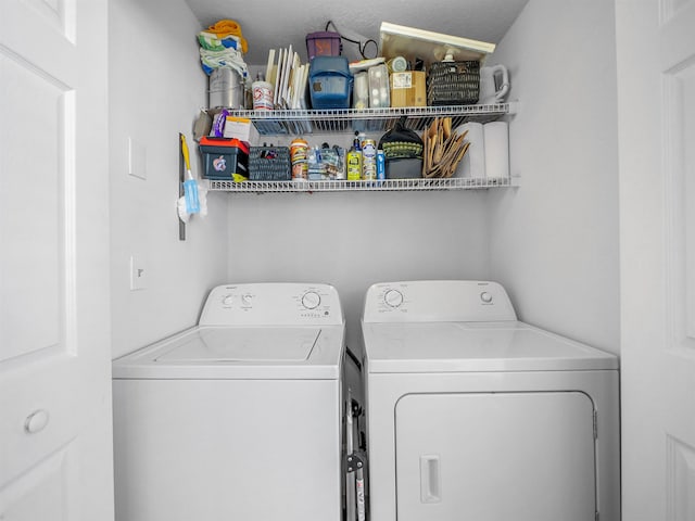 clothes washing area featuring washing machine and dryer and laundry area