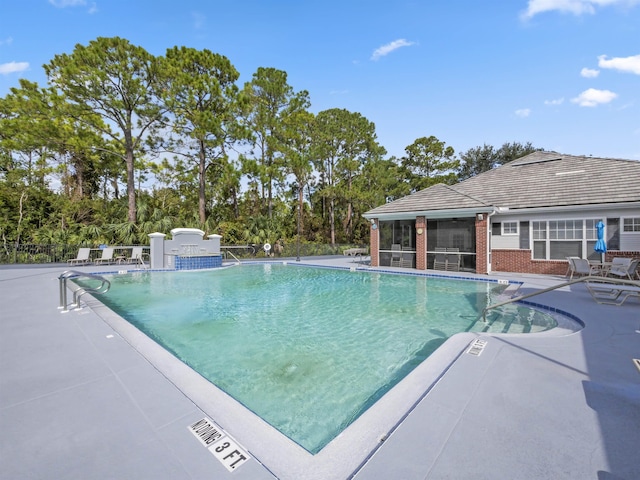 community pool featuring a patio and a sunroom