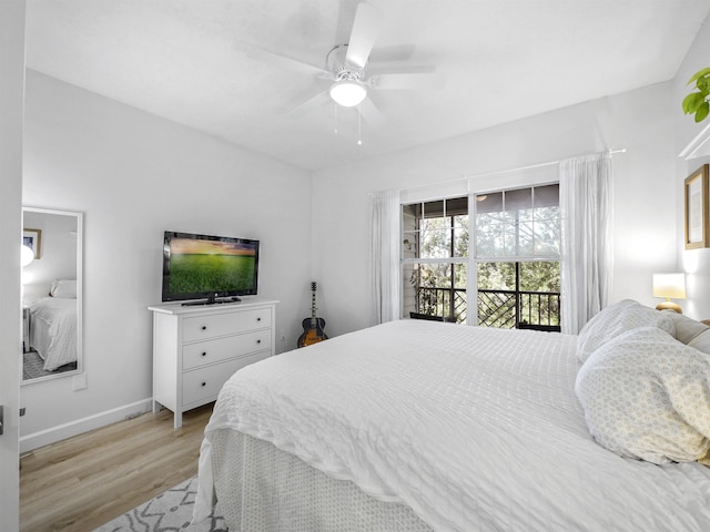 bedroom featuring access to outside, light hardwood / wood-style flooring, and ceiling fan