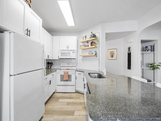 kitchen featuring white appliances, light hardwood / wood-style flooring, white cabinetry, and sink