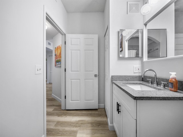 bathroom featuring hardwood / wood-style flooring and vanity