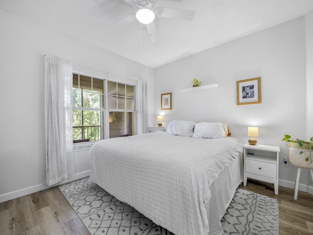 bedroom with baseboards, a ceiling fan, and wood finished floors