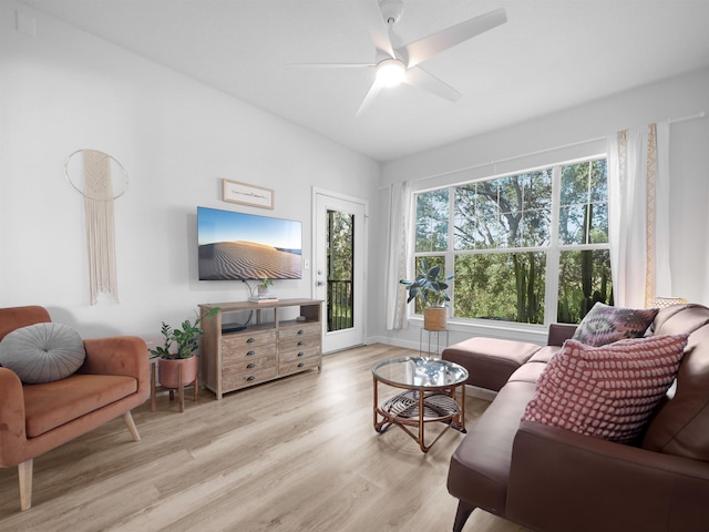 living room featuring light wood-type flooring, plenty of natural light, and ceiling fan