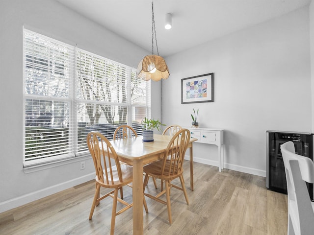 dining room featuring light wood-type flooring and a wealth of natural light