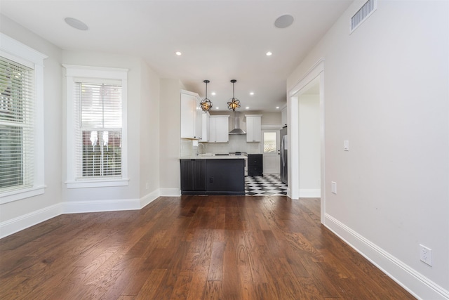 44 Carrera St, Saint Augustine, FL 32084 - unfurnished living room with dark wood-style flooring, baseboards, and recessed lighting