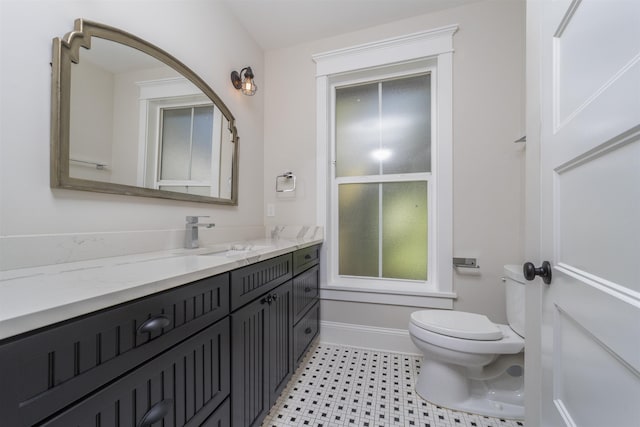 44 Carrera St, Saint Augustine, FL 32084 - bathroom featuring toilet, vanity, and baseboards