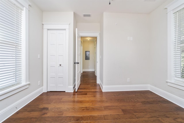 44 Carrera St, Saint Augustine, FL 32084 - unfurnished bedroom featuring dark wood-style flooring and multiple windows