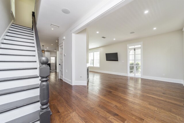 44 Carrera St, Saint Augustine, FL 32084 - unfurnished living room with hardwood / wood-style floors, stairs, baseboards, and recessed lighting