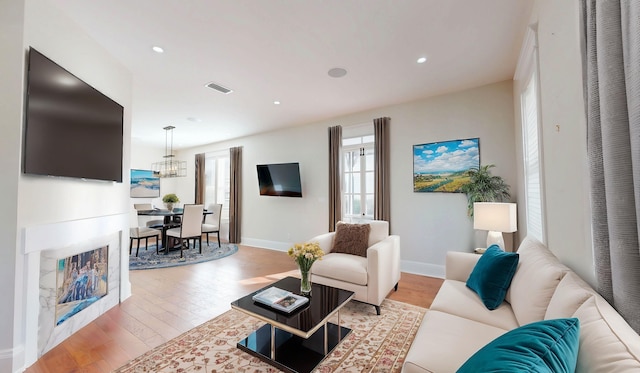 44 Carrera St, Saint Augustine, FL 32084 - living area with healthy amount of natural light, light wood finished floors, a chandelier, and recessed lighting