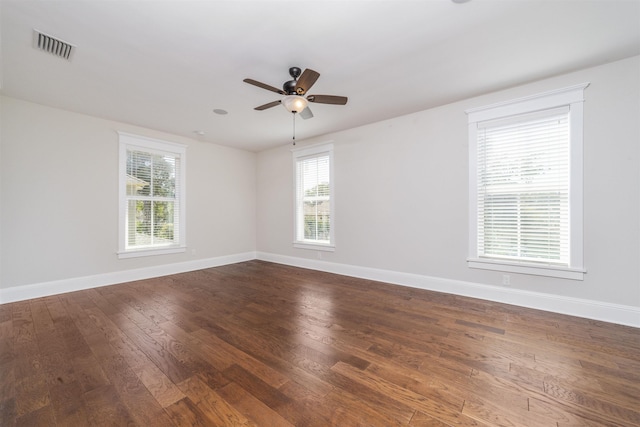 44 Carrera St, Saint Augustine, FL 32084 - empty room with healthy amount of natural light, dark wood-style floors, ceiling fan, and baseboards