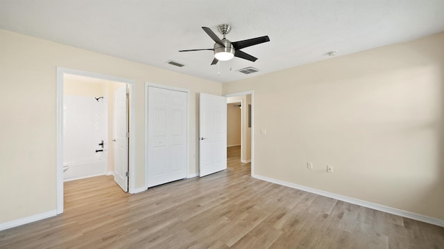 3416 6th St, Elkton, FL 32033 - unfurnished bedroom with light wood-style floors, ensuite bath, a ceiling fan, and a closet