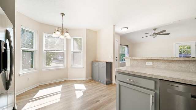 3416 6th St, Elkton, FL 32033 - kitchen with gray cabinetry, stainless steel appliances, a chandelier, light wood finished floors, and vaulted ceiling
