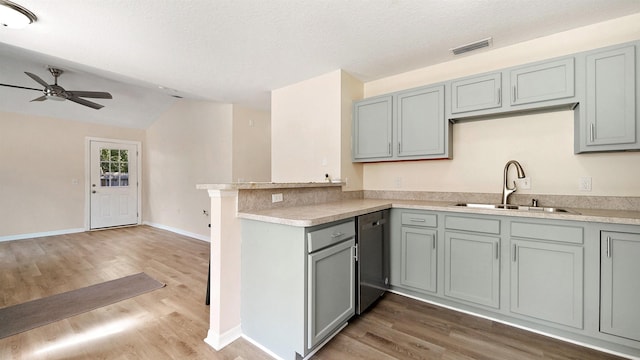 3416 6th St, Elkton, FL 32033 - kitchen with gray cabinets, dishwasher, a peninsula, lofted ceiling, and ceiling fan