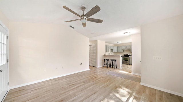 3416 6th St, Elkton, FL 32033 - unfurnished living room with a ceiling fan, light wood-type flooring, and lofted ceiling
