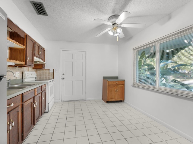 kitchen with sink, ceiling fan, decorative backsplash, light tile patterned floors, and white electric range oven