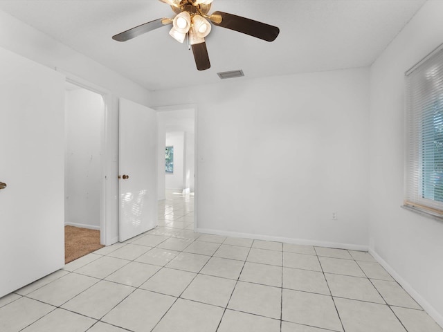 unfurnished room featuring ceiling fan and light tile patterned flooring