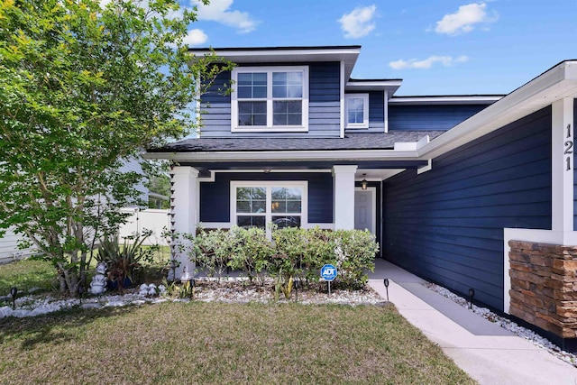 121 Sawmill Forest Ct, Saint Augustine, FL 32086 - property entrance featuring a lawn, roof with shingles, and a porch