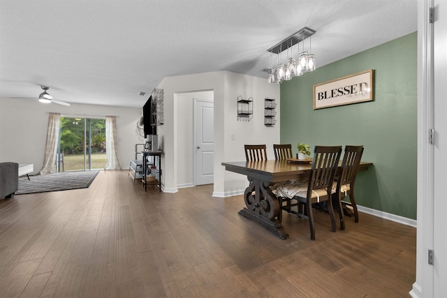 121 Sawmill Forest Ct, Saint Augustine, FL 32086 - dining area with a textured ceiling, baseboards, ceiling fan with notable chandelier, and wood finished floors