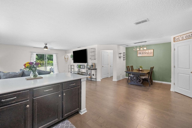 121 Sawmill Forest Ct, Saint Augustine, FL 32086 - kitchen featuring visible vents, open floor plan, light countertops, dark wood finished floors, and ceiling fan with notable chandelier