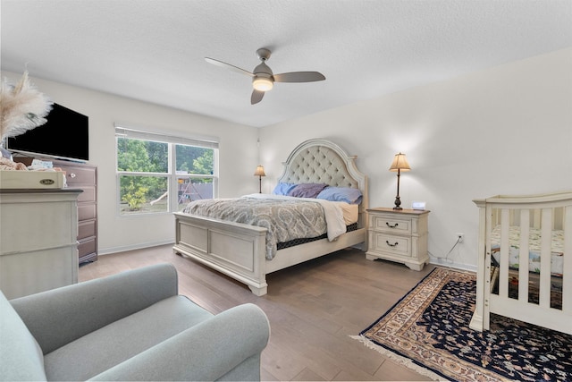 121 Sawmill Forest Ct, Saint Augustine, FL 32086 - bedroom with baseboards, a ceiling fan, a textured ceiling, and wood finished floors