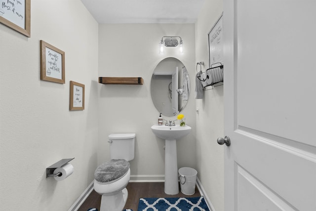 121 Sawmill Forest Ct, Saint Augustine, FL 32086 - bathroom featuring baseboards, wood finished floors, and toilet