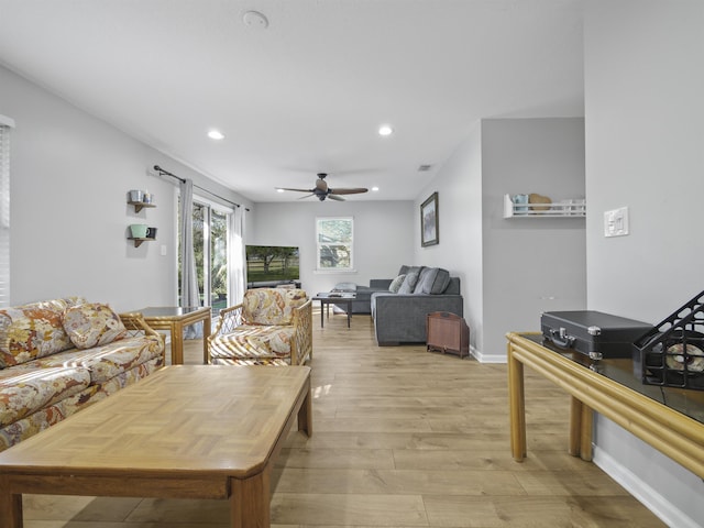 living room with ceiling fan and light hardwood / wood-style floors