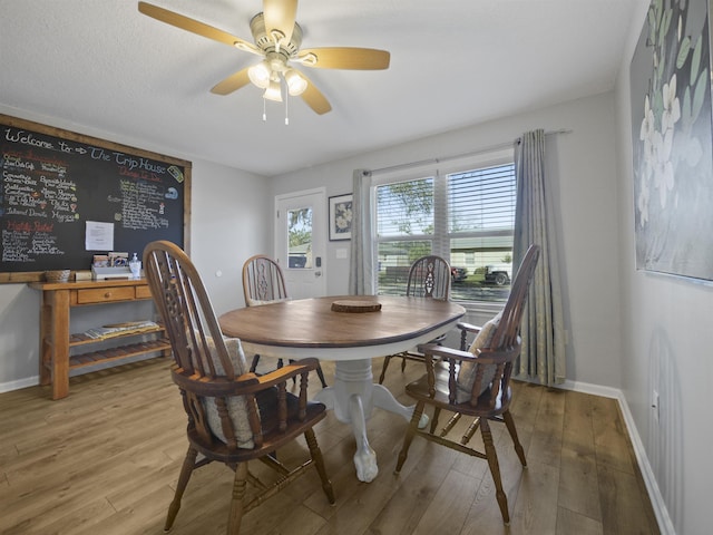 dining space featuring hardwood / wood-style floors and ceiling fan