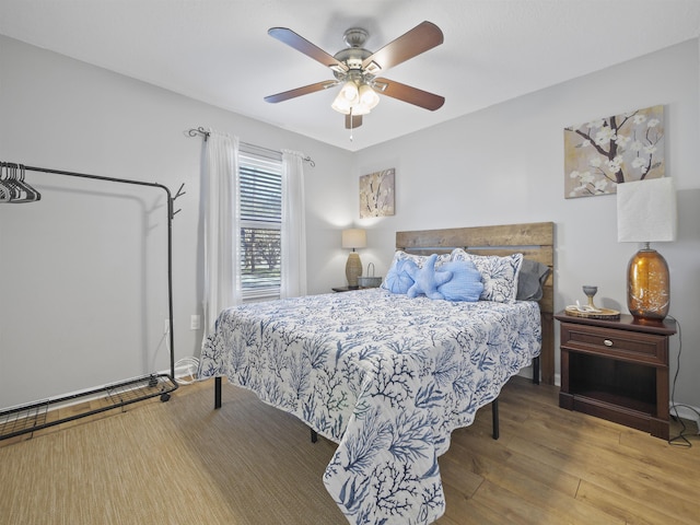 bedroom with hardwood / wood-style flooring and ceiling fan