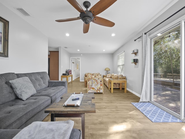 living room with ceiling fan and light wood-type flooring