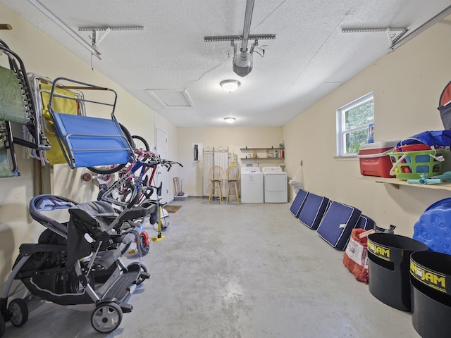 garage featuring washing machine and dryer and a garage door opener